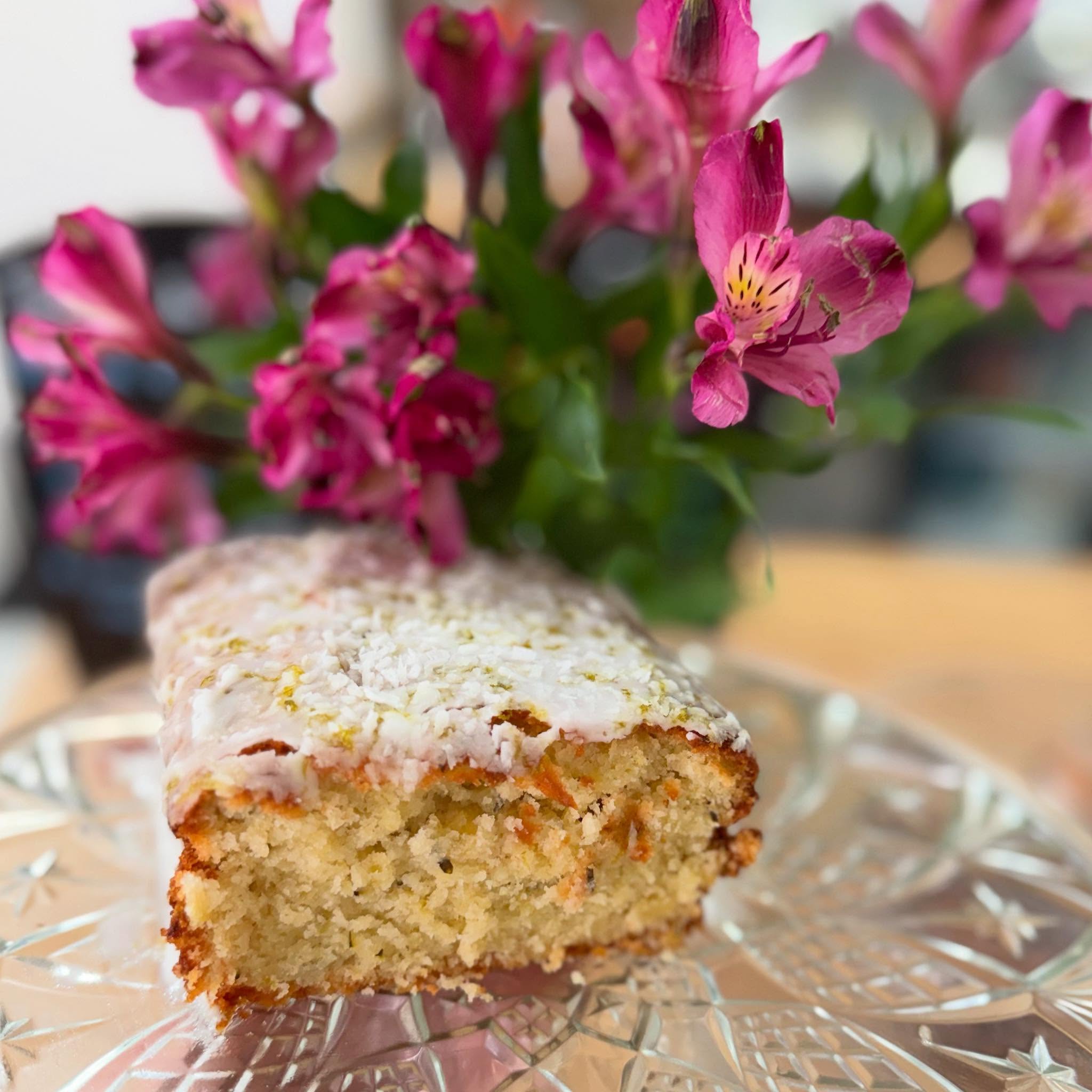 Nook’s whole courgette, lime and coconut loaf with flowers behind it